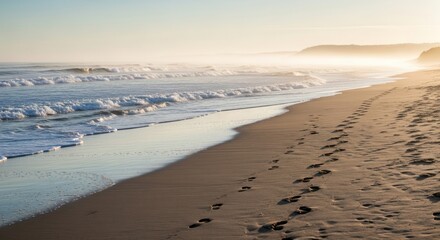 Footprints in Golden Sand at Serene Ocean Beach with Misty Sunrise or Sunset