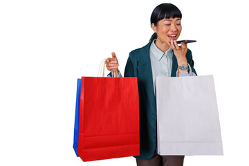 Asian woman speaking into smartphone holding colorful shopping bags, sending voice message enjoying retail therapy, transparent background