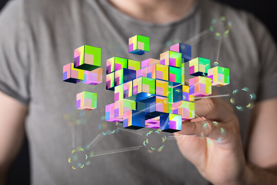 Digital abstract of cubes with colorful gradients emerging from a person's hand, representing innovation and te