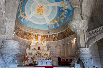 Obraz premium Viana do Castelo, Portugal. Interior view of the Sanctuary of Santa Luzia showing the main altar and the dome frescoes, allegory of the Sacred Heart of Jesus in Byzantine and Romanesque Revival