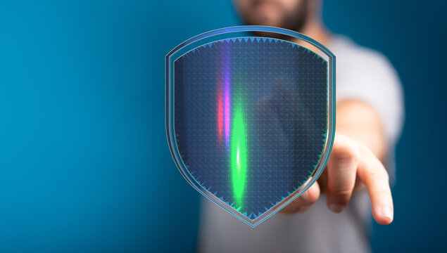 Abstract concept of data protection and cyber security represented with shield and person's hand. Digital defense illustration of a f