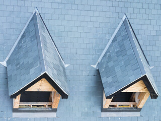 Drone inspection view of new dorms and attic roofs showing the wooden frame structures before window fitting. The ceramic roof tiles can be seen.