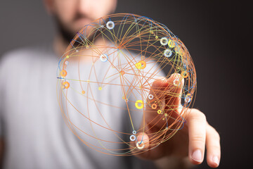 Image of a person interacting with a 3D rendered sphere representing the world wide web,...