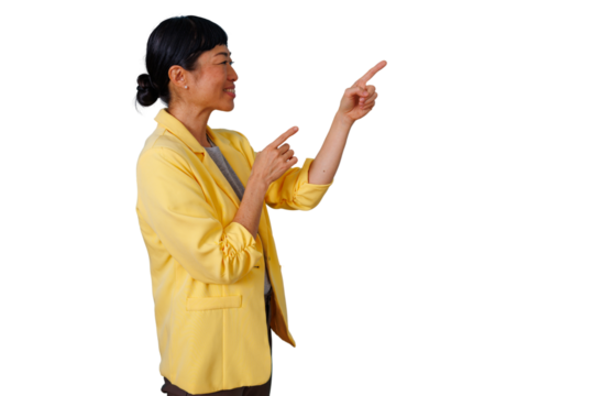 Asian businesswoman smiling, pointing both index fingers, showing direction or presenting information on a transparent background