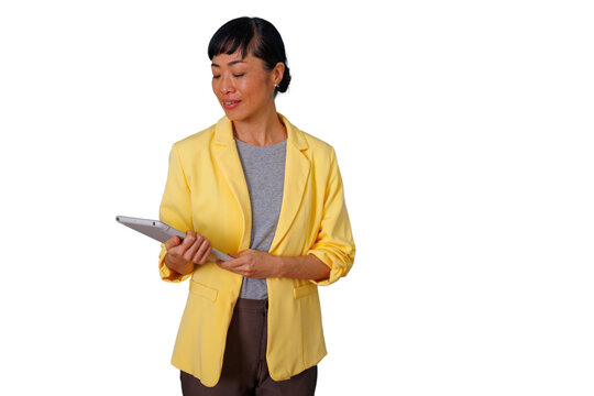 Asian business woman in yellow blazer holding a tablet, managing corporate tasks, transparent background - Powered by Adobe
