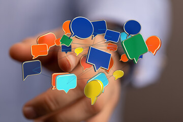 Hand holding interconnected colorful speech bubbles, representing communication, social networking,...