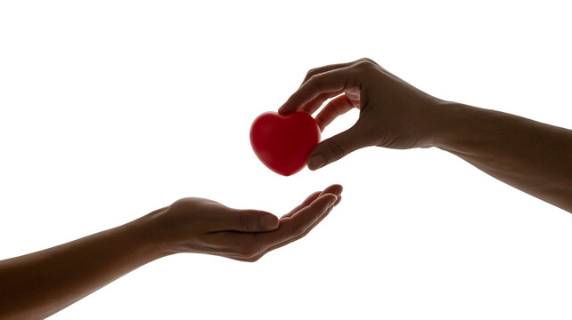 Generous hand offers red heart symbol to open palm, conveying compassion, love, and selfless giving in a moment of connection