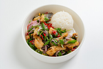 Freshly prepared fish salad features herbs, vegetables, and rice, creating a colorful meal