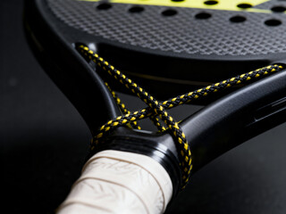 Detailed Close-Up of Padel Racket Handle with Braided Cord and Carbon Fiber Frame