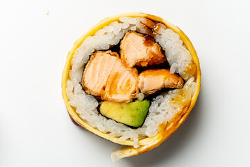 Savor the taste of a sushi roll filled with salmon and avocado, beautifully arranged for enjoyment