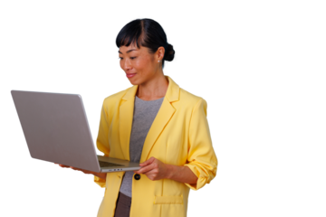 Asian businesswoman in yellow jacket working on a laptop, standing and concentrating on screen, transparent background