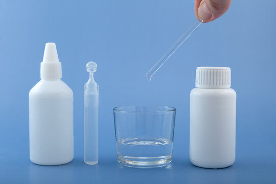 Drop of silicone oil drips from pipette into glass. Different packages Polydimethylsiloxane (PDMS), also known as dimethylpolysiloxane or dimethicone. Food additive E900. Polymerized siloxane