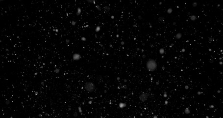 Falling snowflakes isolated on black background. Winter snow overlay texture for VFX, compositing, motion graphics and atmospheric effects