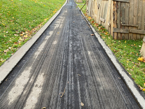 Road repair. Surface ready for paving. Asphalt milling machine removed the top layer of road surface. City street, pavement. Repairs were delayed. Milled asphalt.