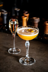 A vibrant cocktail with a passion fruit garnish sits on the bar, setting the perfect vibe