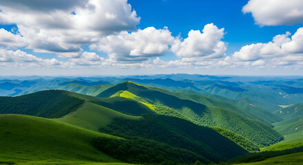 Vast green mountain range under a dramatic cloudy sky