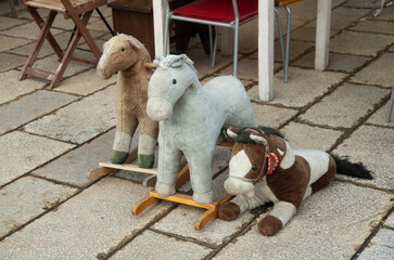 Three colorful old plush rocking horses closeup