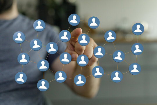 Hand touching digital network of people, representing social media, networking, communication, and connectivity