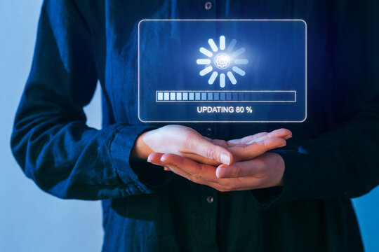 Hands holding a digital update bar indicating progress at eighty percent during a tech discussion indoors