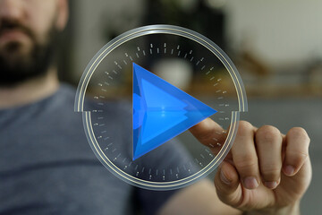 A man's hand interacting with a holographic play button, symbolizing technology, media, and digital interface. Perfect for tech, inno