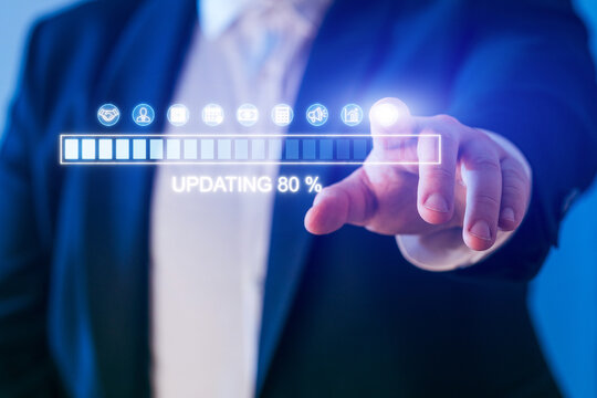 Business professional updating digital information on a transparent interface during a corporate meeting in an office setting