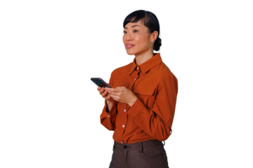 East asian woman standing, holding smartphone, wearing casual business attire, looking away on transparent background