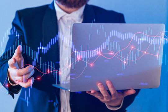 Business professional presenting financial data trends on laptop during a conference setting