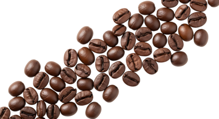 Scattered roasted coffee beans on a white surface