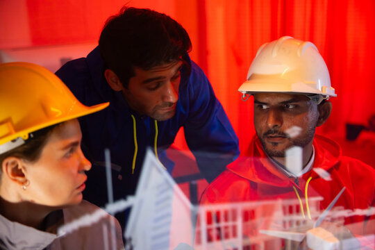 Modern construction and engineering Team Collaborating on Futuristic Holographic Interface Analyzing. Holographic Technology for Innovative house Development Planning - Powered by Adobe