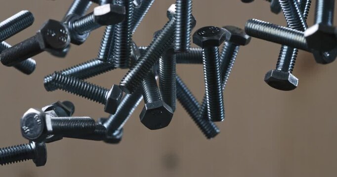 Slow Motion Macro Shot Of Metal Bolts Floating And Colliding In Mid-Air With Dynamic Mechanical Motion, Detailed Reflections, Industrial And Precise Metallic Energy At 1000 Fps. 