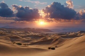 Golden sunset illuminates rolling desert dunes under a dramatic cloudy sky