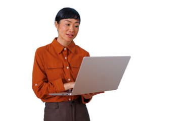Asian businesswoman standing, typing on laptop, reviewing information on technology, connecting with digital content