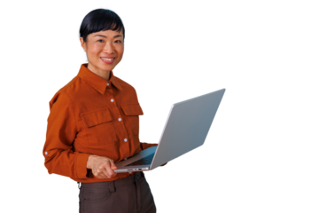 Asian businesswoman smiling and holding a laptop, confidently managing online tasks, isolated with a transparent background