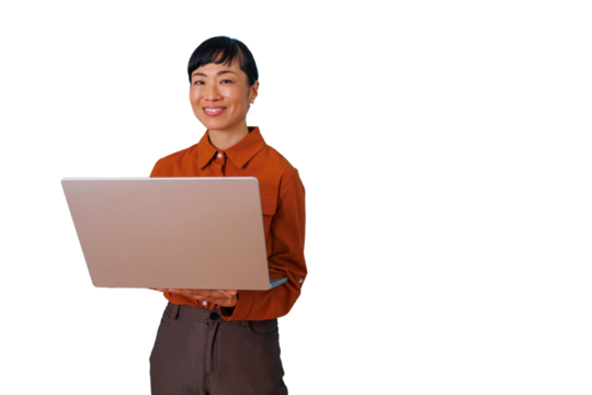 Asian woman standing and smiling, working on laptop, developing business strategy with transparent background