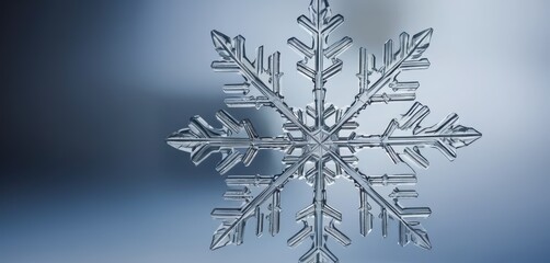 Close up view of a single detailed ice crystal snowflake with a gradient blue background