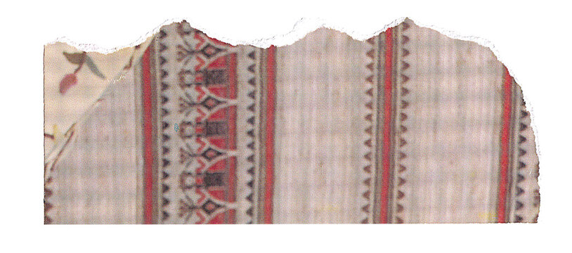 A fragment of torn textile featuring intricate patterns with vertical red and black striped bands and scattered floral motifs on a light background, showcasing a historical or artisanal fabric.