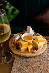 Gourmet Cheese Platter with Assorted Cheeses, Fruits, and Honey