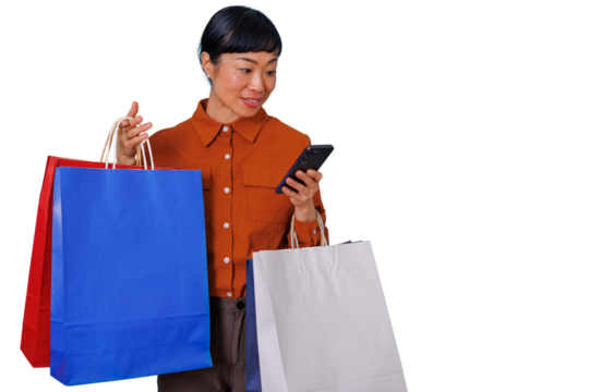 Asian woman holding colorful shopping bags and looking at her smartphone, representing the convenience of digital purchasing