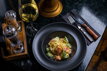 Gourmet Salmon Pasta Dish with Wine - Fine Dining Experience