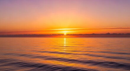 Obraz premium Vibrant Golden Sunset Over Calm Ocean Horizon with Reflective Water Surface