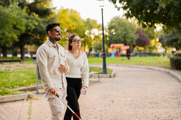 Blind partner walking with assistance in park