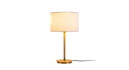 A modern brass table lamp with a white cylindrical shade illuminates a room with a warm soft glow against a stark black background highlighting its elegant design and functionality as a home or