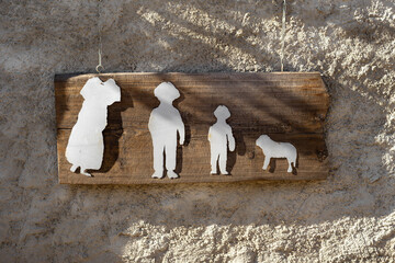 Rustic Wooden Sign with Silhouettes of sheep and People