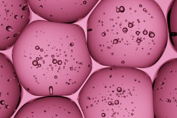 Macro capture of pink gel blobs holding trapped air bubbles, crafted for editorial beauty layouts, biotech concepts, and contemporary advertising visuals