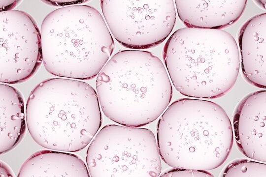 Macro shot of translucent pink gel beads with internal bubbles, perfect for beauty-focused ads, clean medical layouts, and polished abstract designs