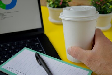 Morning workspace with takeaway coffee cup