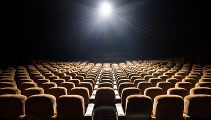 empty theater seats illuminated by a single beam of light in a dark room creating a dramatic and...