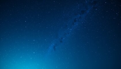 Fototapeta premium Vast clear night sky showcasing countless stars and a faint milky way galaxy stretching across