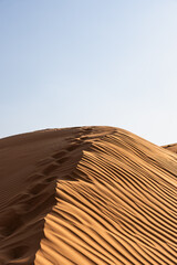 Desert sand dune showing footprints and sand ripples