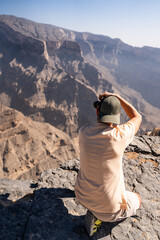 Man photographing jebel shams grand canyon oman landscape